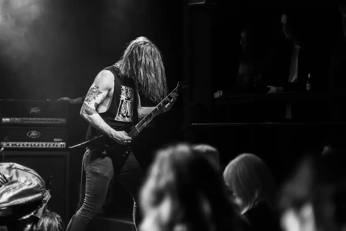 Band performing on stage with intense lighting and dynamic energy
