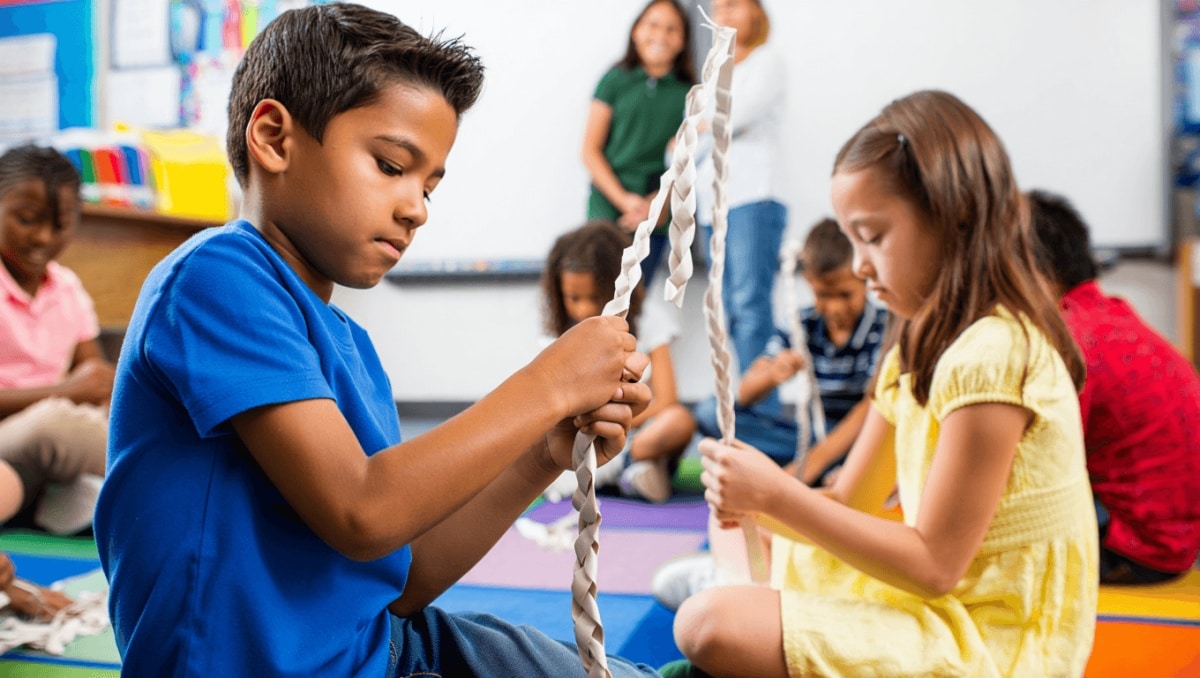 Left over center, right over center — 2nd graders are braiding a 'Story Rug'