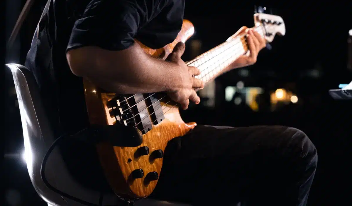A guitarist performing on stage with a kinetic, energetic stance during a live rock concert.
