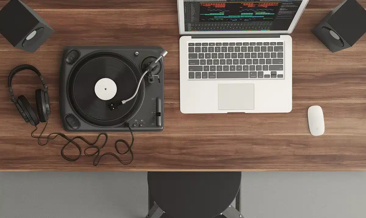 Producer at mixing console in modern recording studio with minimal equipment