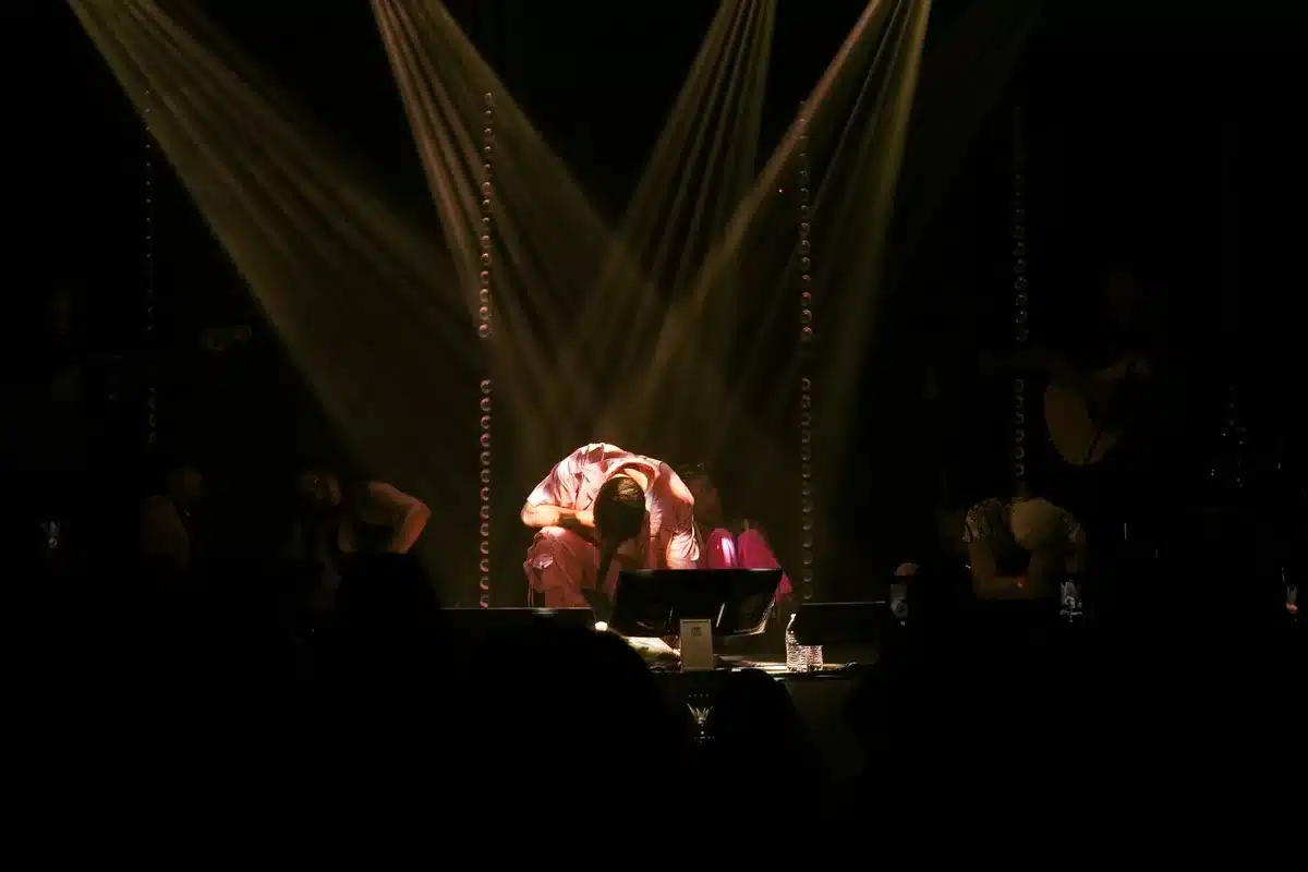 Theater audience experiencing immersive visual projection and surround sound staging