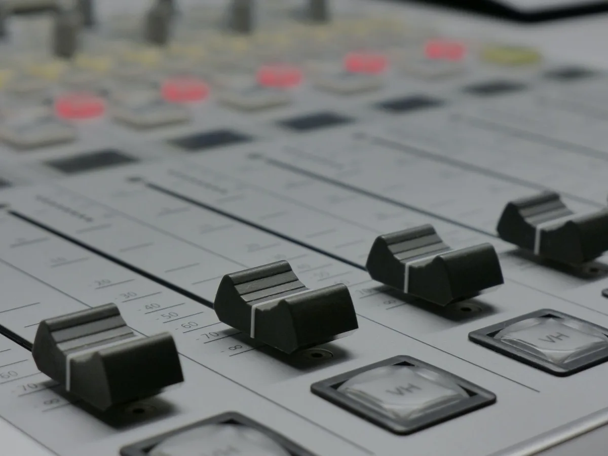 Professional recording studio setup with mixing console and audio equipment
