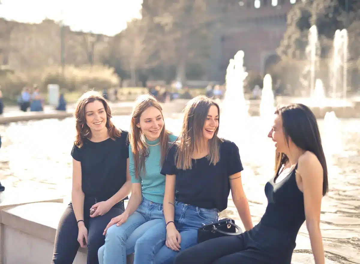 Group of friends sitting together in a casual, warm setting, representing the communal viewing experience