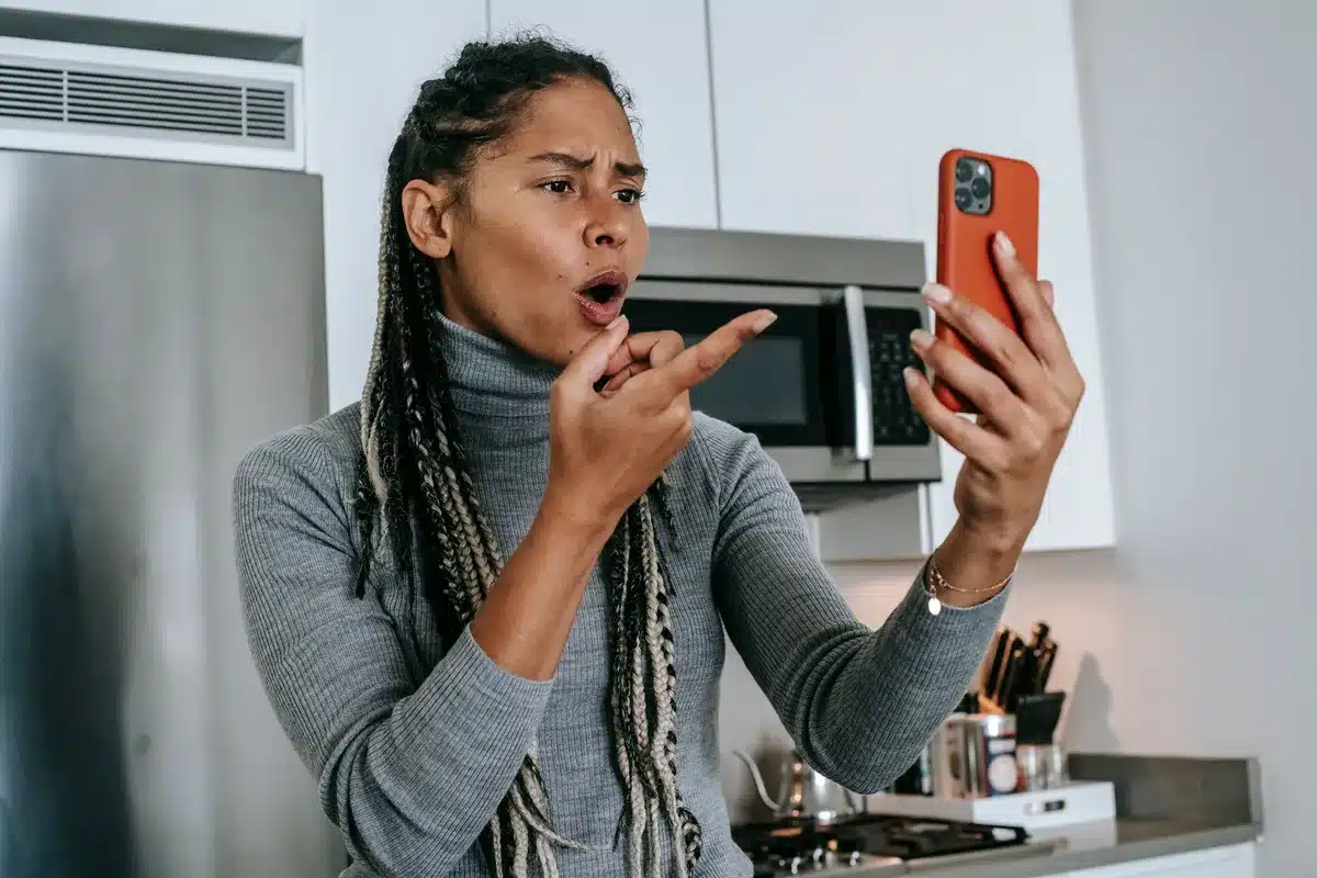 Smartphone screens showing social media posts and heated online debate between users