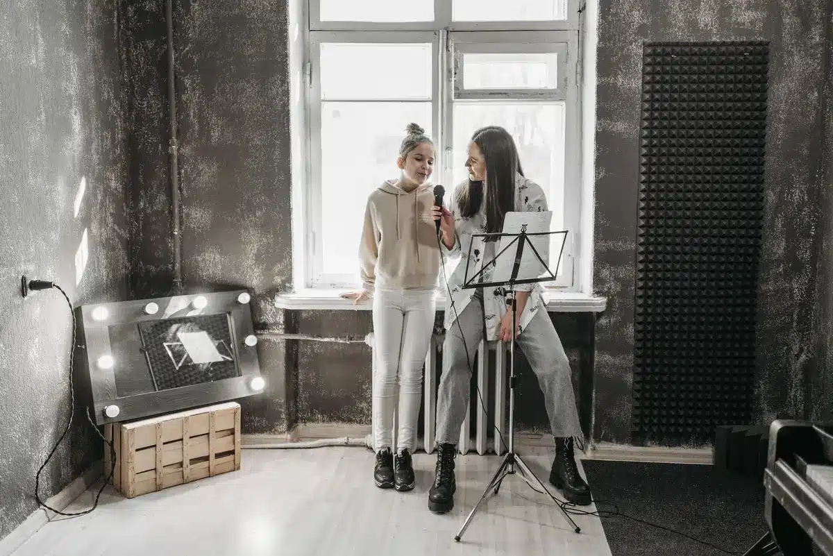 Ein Sänger während einer Vokaltrainingseinheit mit Coaching-Unterstützung im Tonstudio