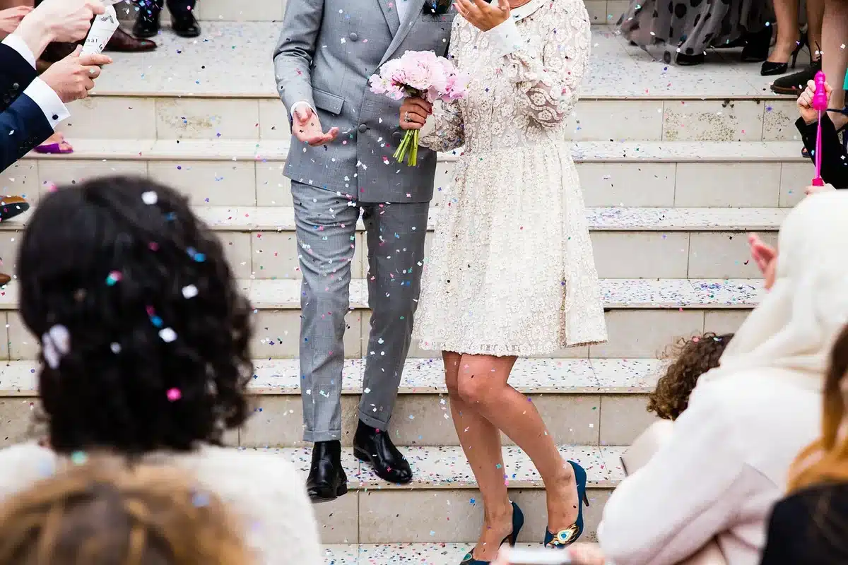 Guests at an intimate wedding ceremony sharing emotional reactions during the service