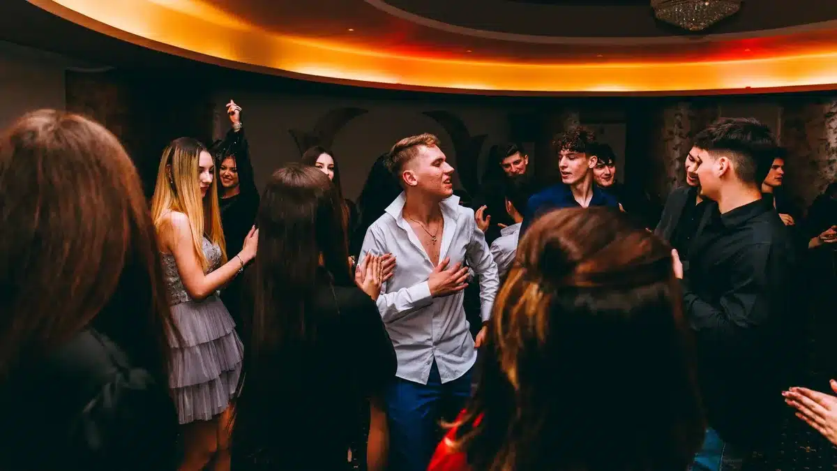 Vintage dancefloor scene with people dancing to early rock and roll music