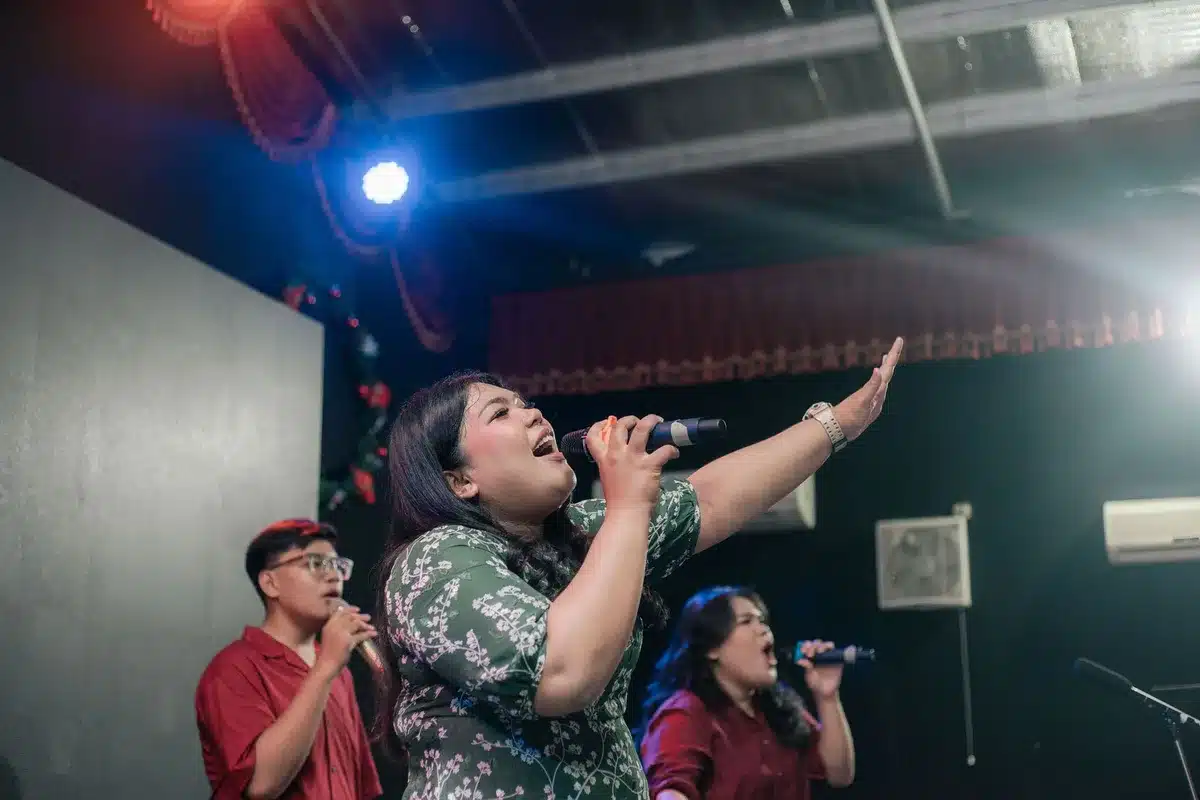 Female vocal group performing together with polished harmonies on stage