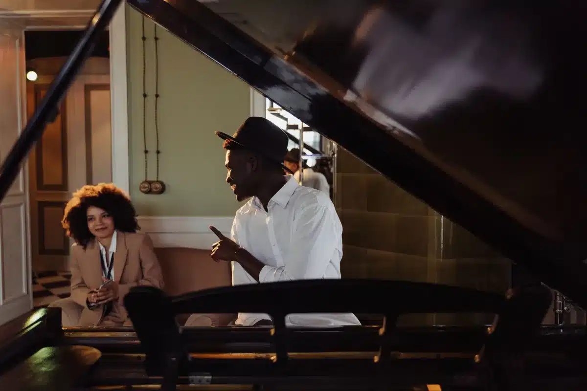 Two people having a close conversation, suggesting communication through music and words.