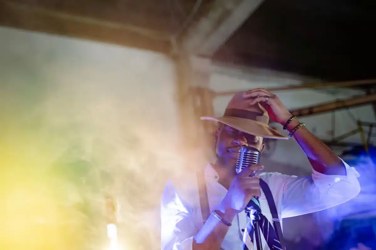 A performer on stage with warm lighting, embodying charisma and stage presence