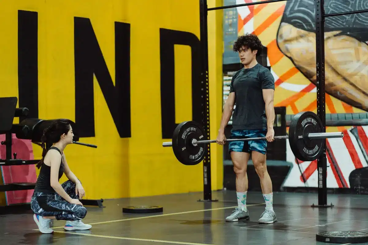 Athlete performing a heavy deadlift with barbell in a gym