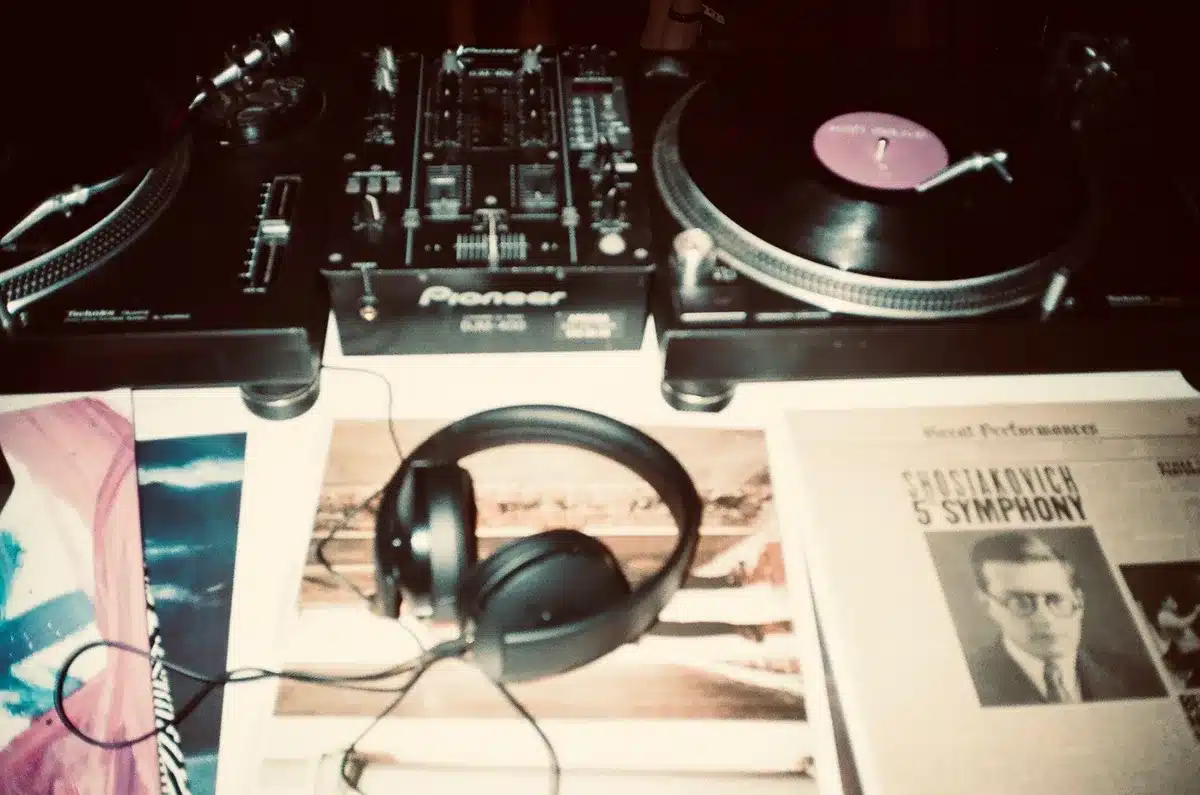 DJ at turntables mixing tracks with headphones on