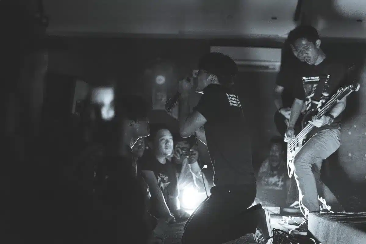 Musicians on stage playing with high energy and intensity during a punk rock show
