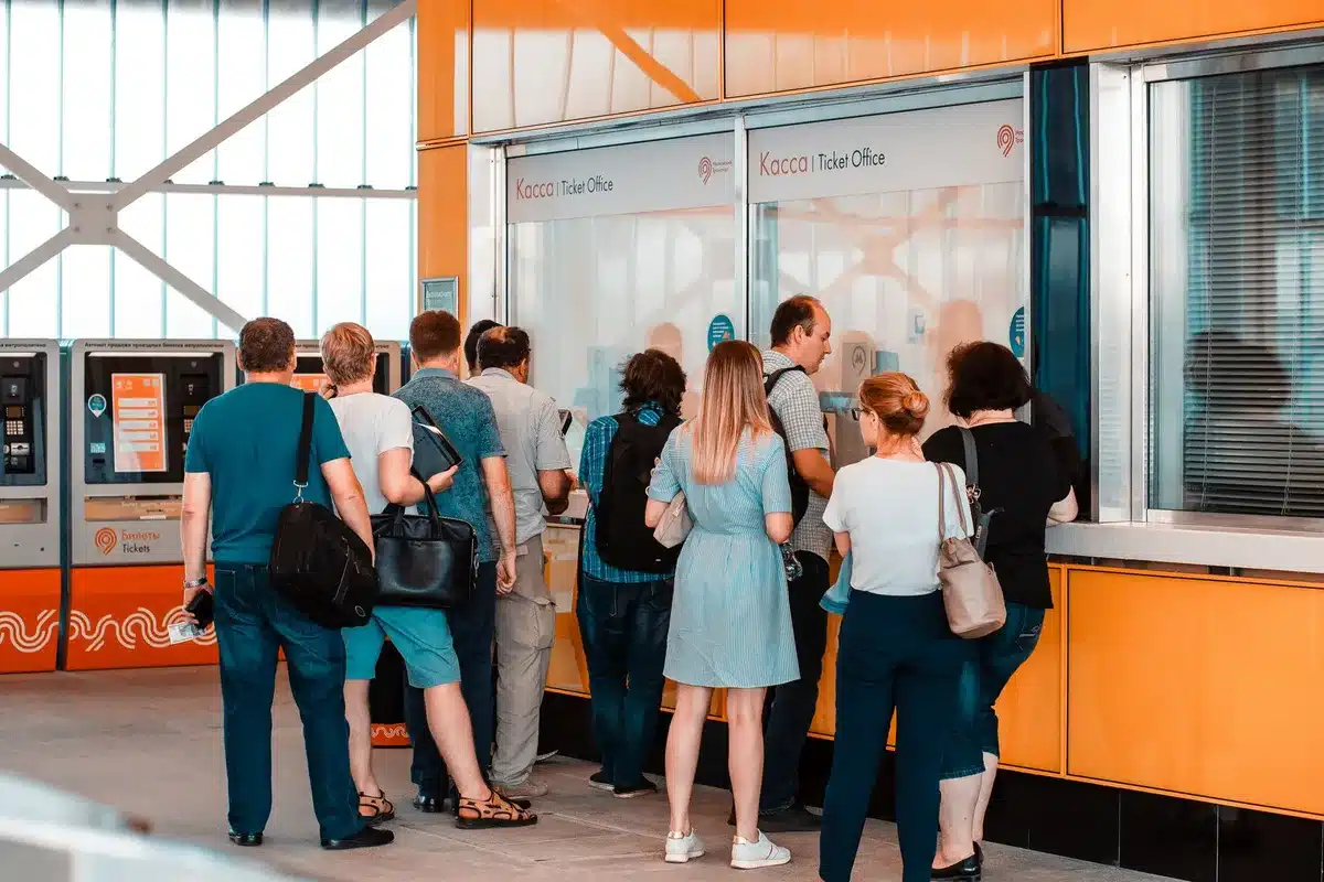 Crowd of people waiting in line at a concert box office