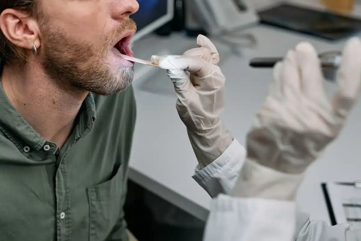 Doctor examining patient's throat during medical evaluation