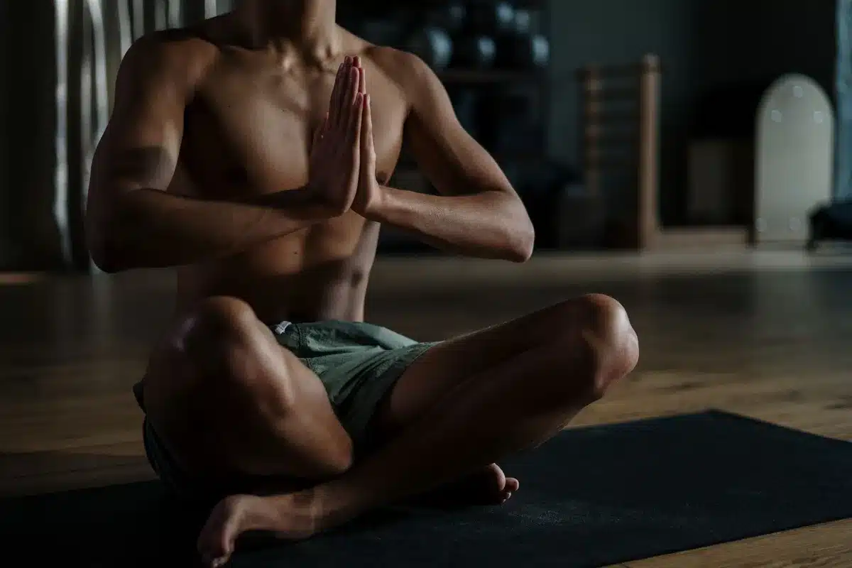 Person meditating in a peaceful studio environment with soft lighting