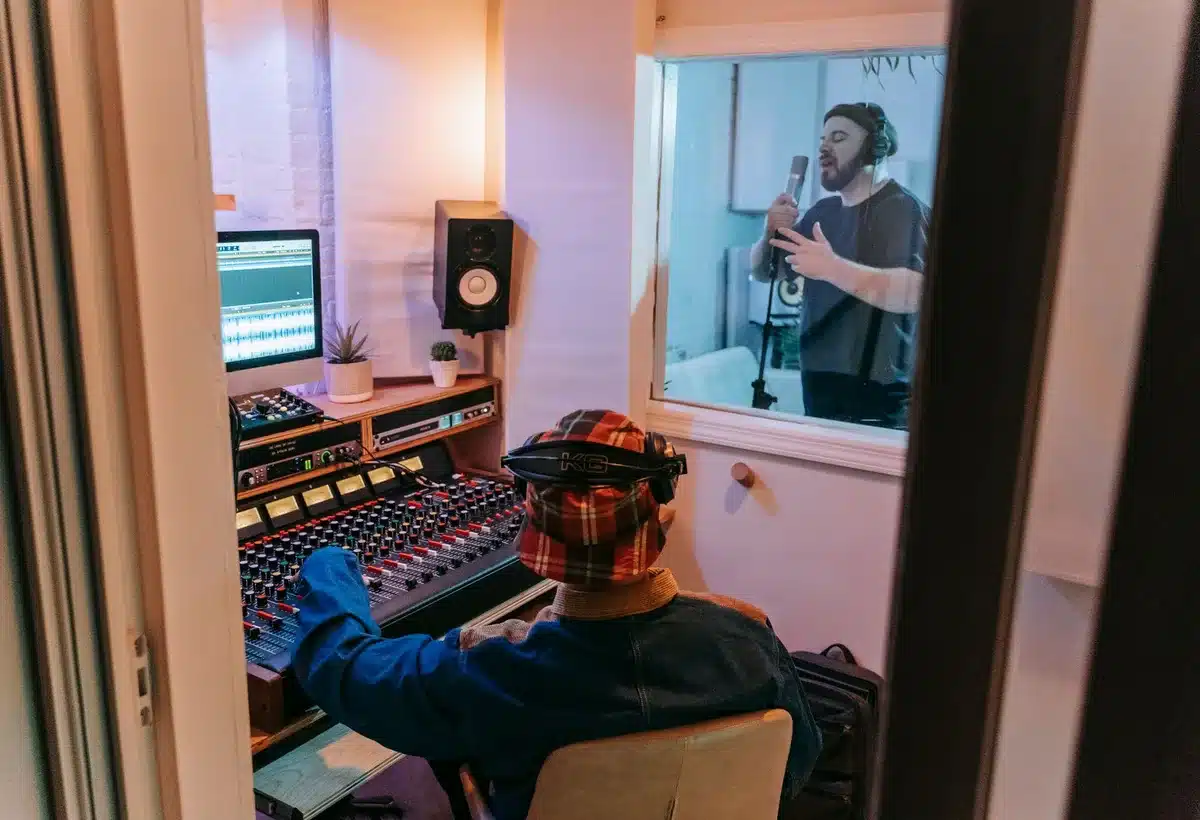 Recording studio with mixing console, microphone, and amplifier during a recording session
