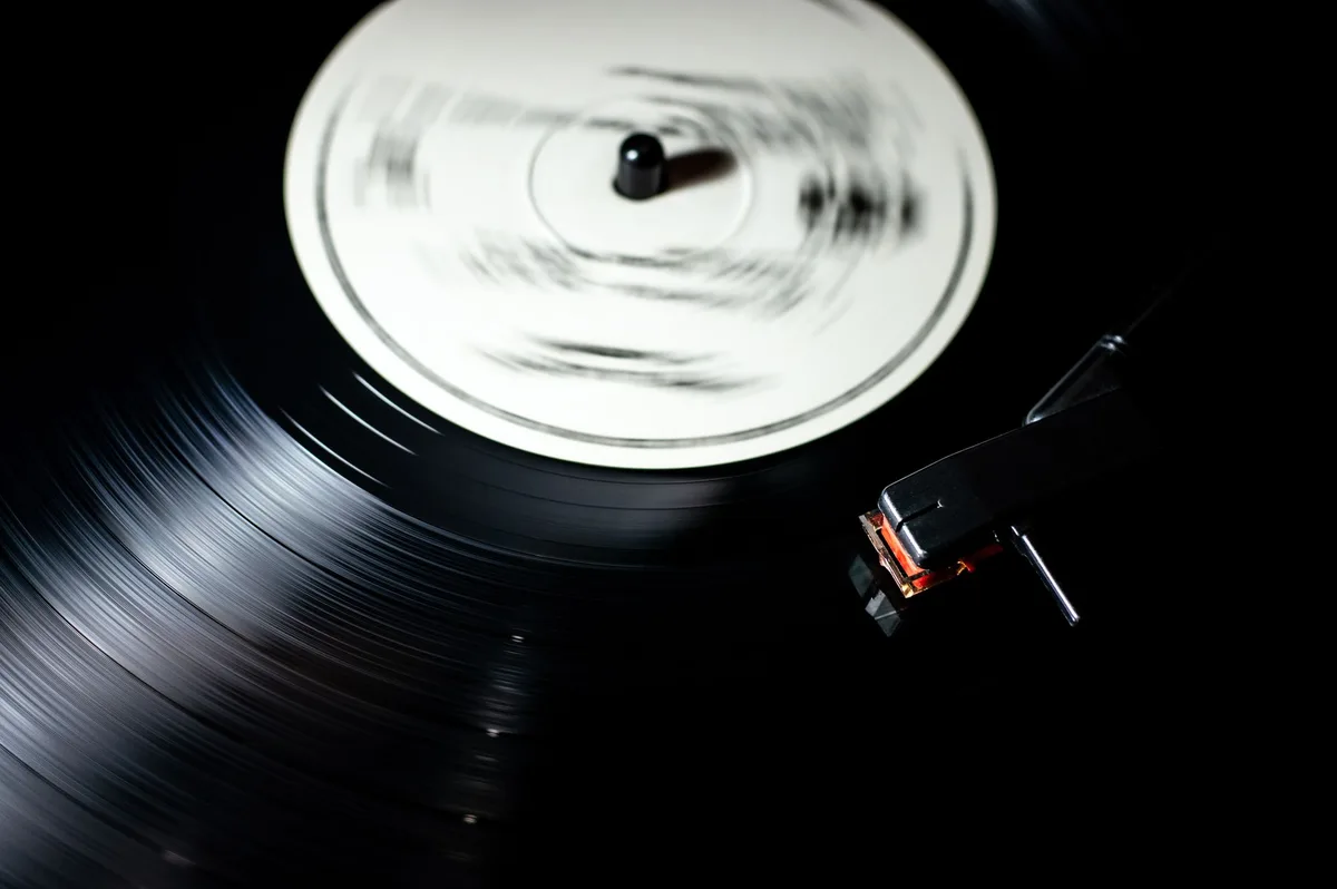 Close-up of a vinyl record spinning on a turntable with visible grooves
