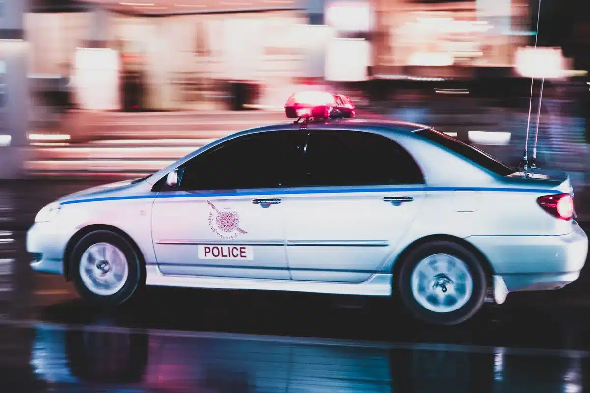 Police patrol car on a dark highway at night during intense confrontation