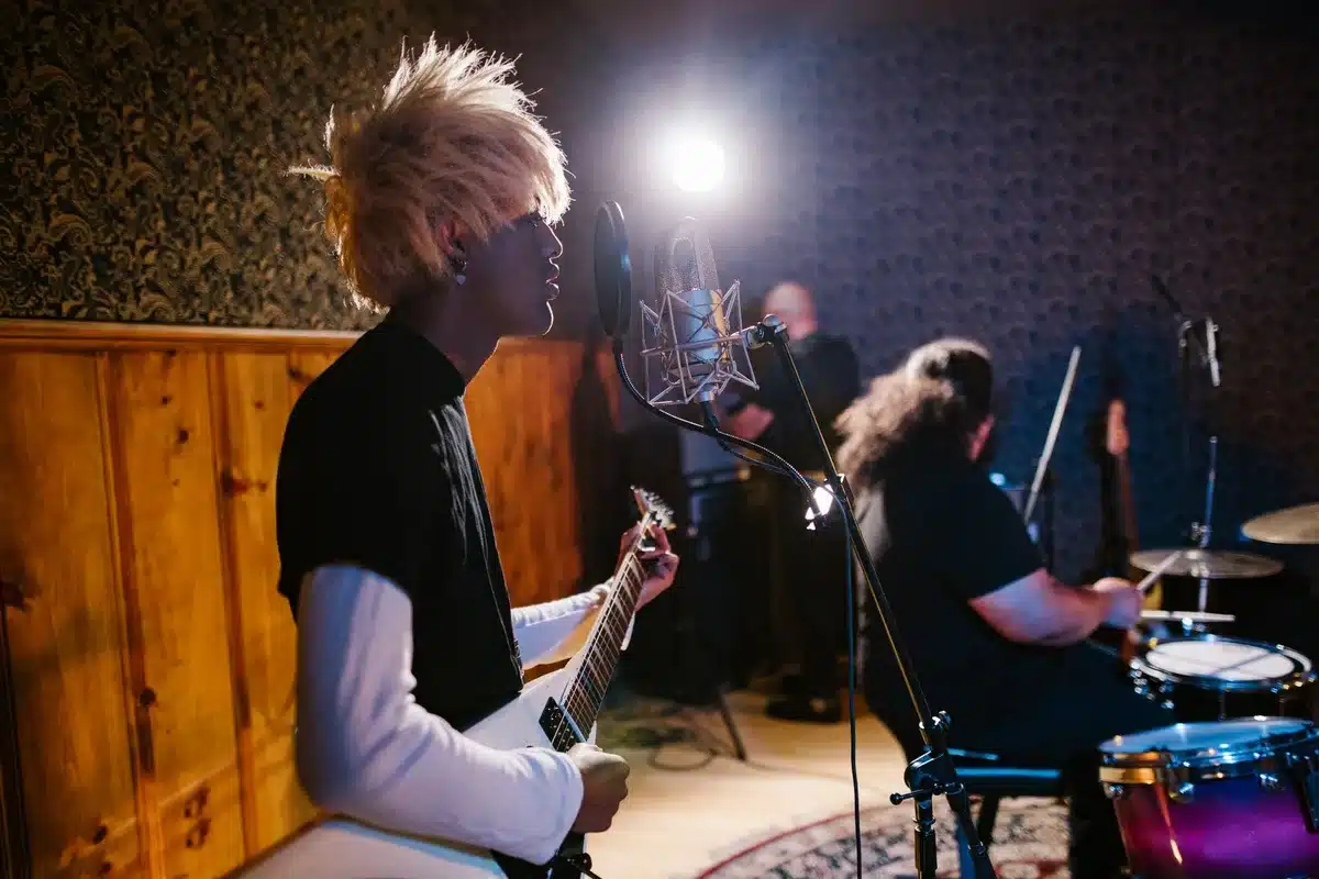 Musicians recording in a studio with raw, energetic guitar tones