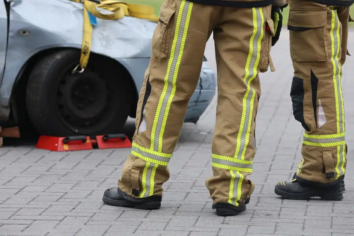 Emergency responders and investigators at a crash scene gathering evidence