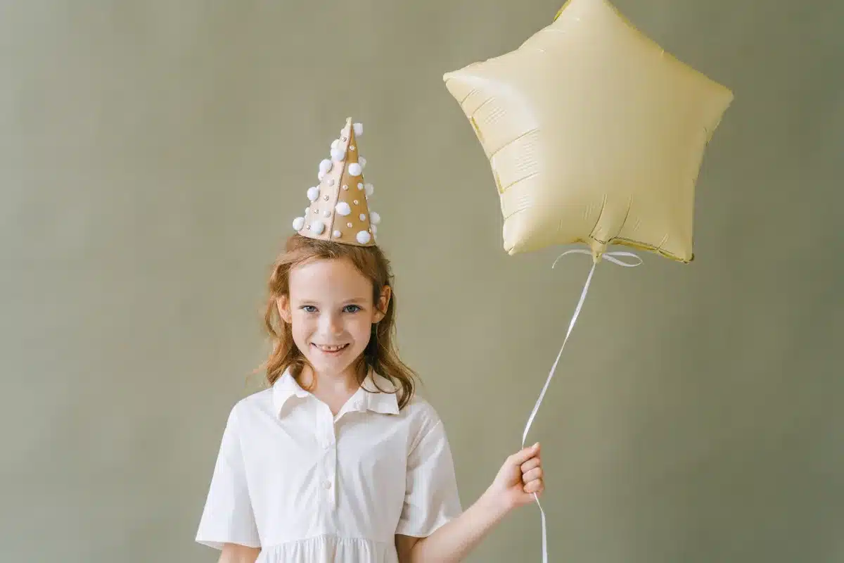 Young child smiling brightly during a joyful birthday celebration moment