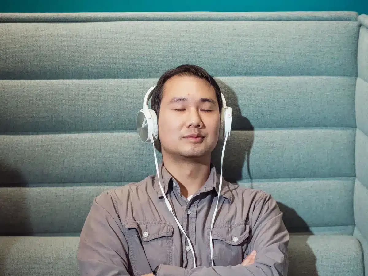 Someone using headphones as a sensory anchor during a moment of temptation or focus.