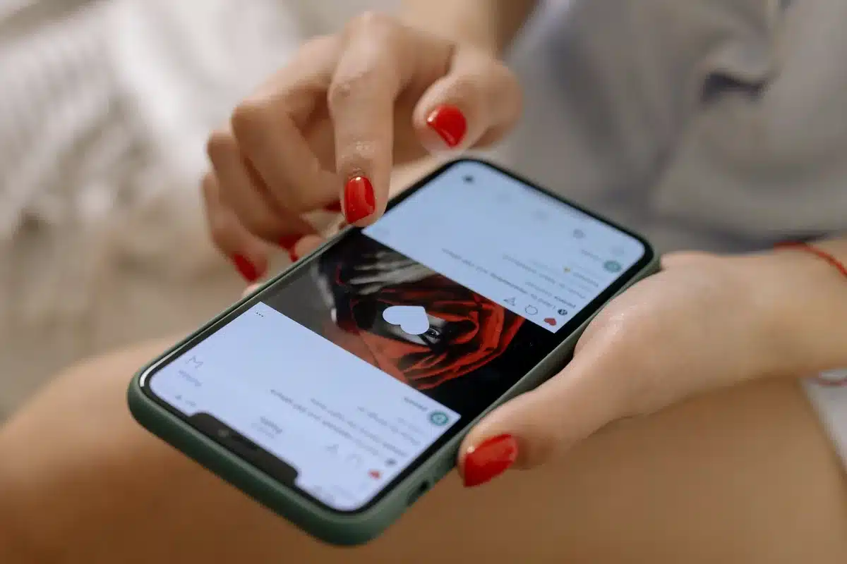 Hands holding smartphones scrolling through viral video clips and comments