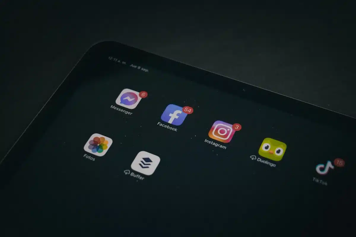 Smartphone screen showing social media app icons and trending video content feeds