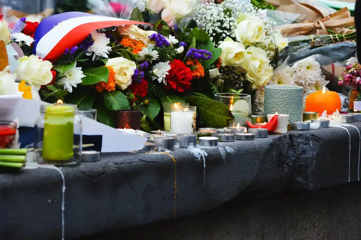Candles and flowers arranged as a memorial tribute to a deceased person