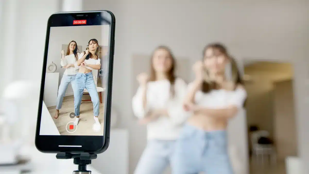 Artist performing a signature dance move in a bedroom setting