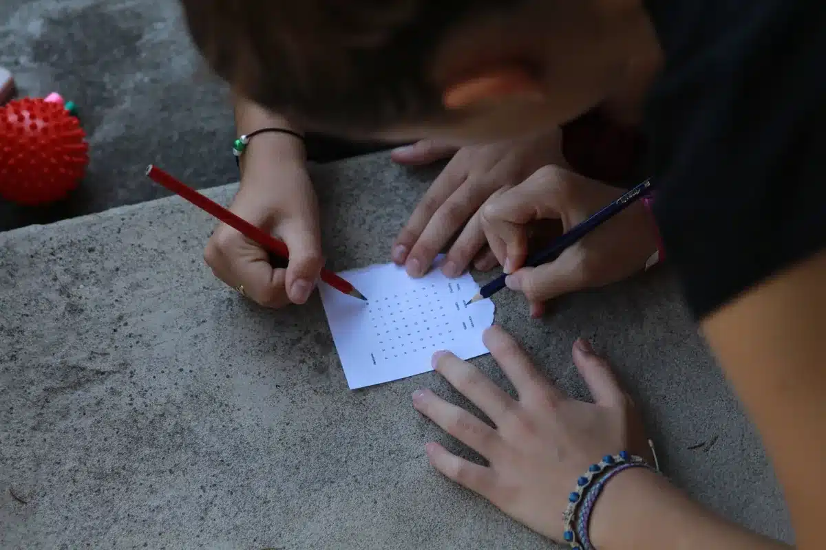 Close-up of a puzzle challenge written on paper with a pencil nearby