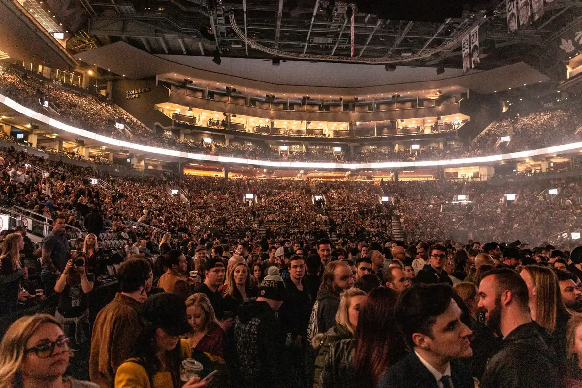 Packed arena with audience seating and stage area