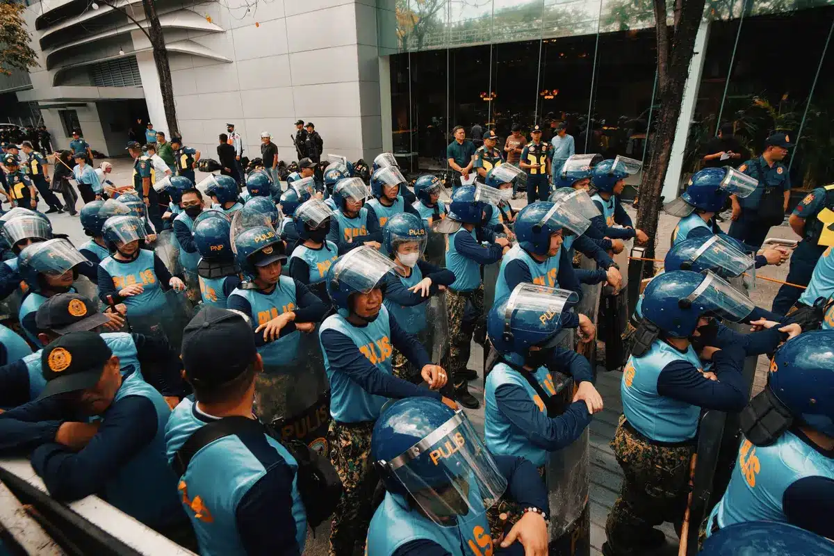 Police officers managing a dispersing crowd at an outdoor event