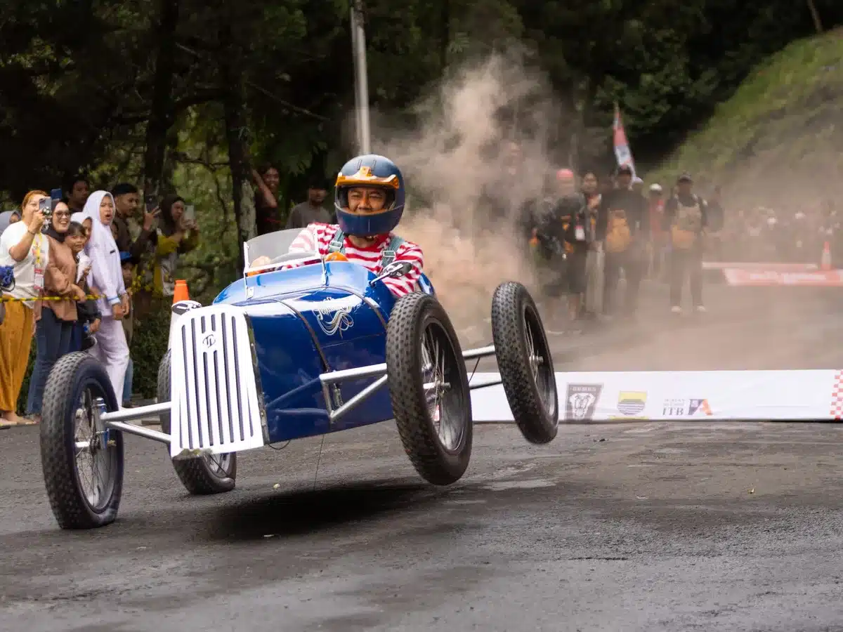 A creative soapbox car decorated with foam, faux fur and colorful props, resembling a fantastical character.