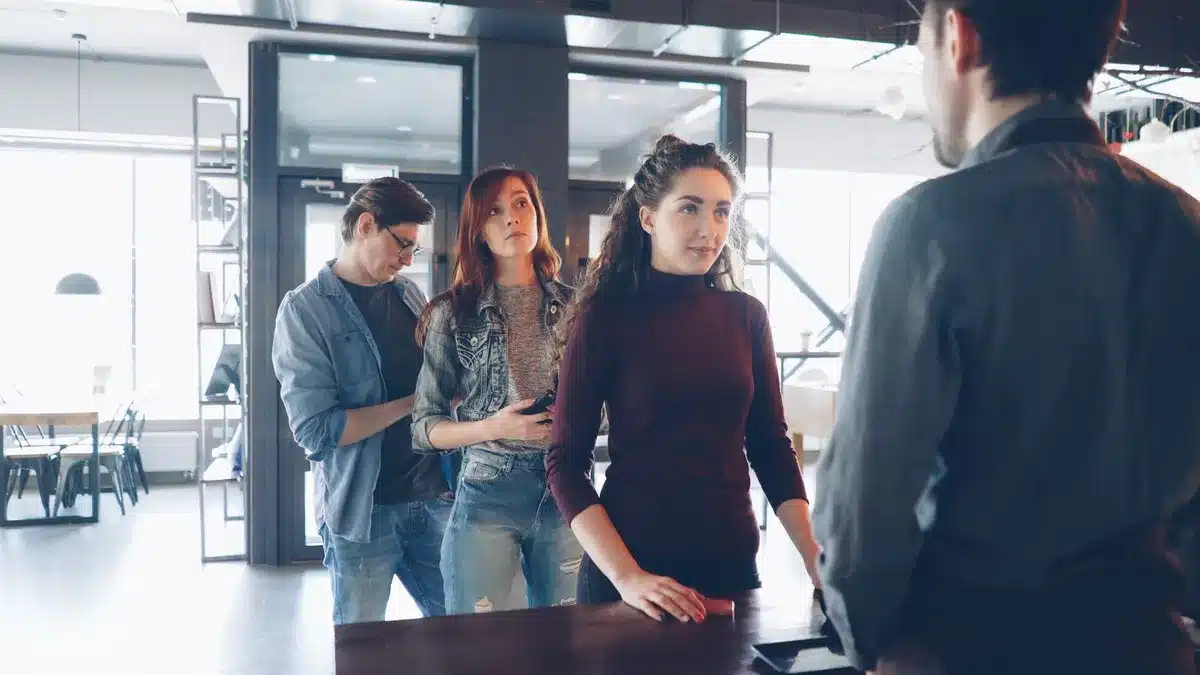 Diverse group of people in a café enjoying beverages together.