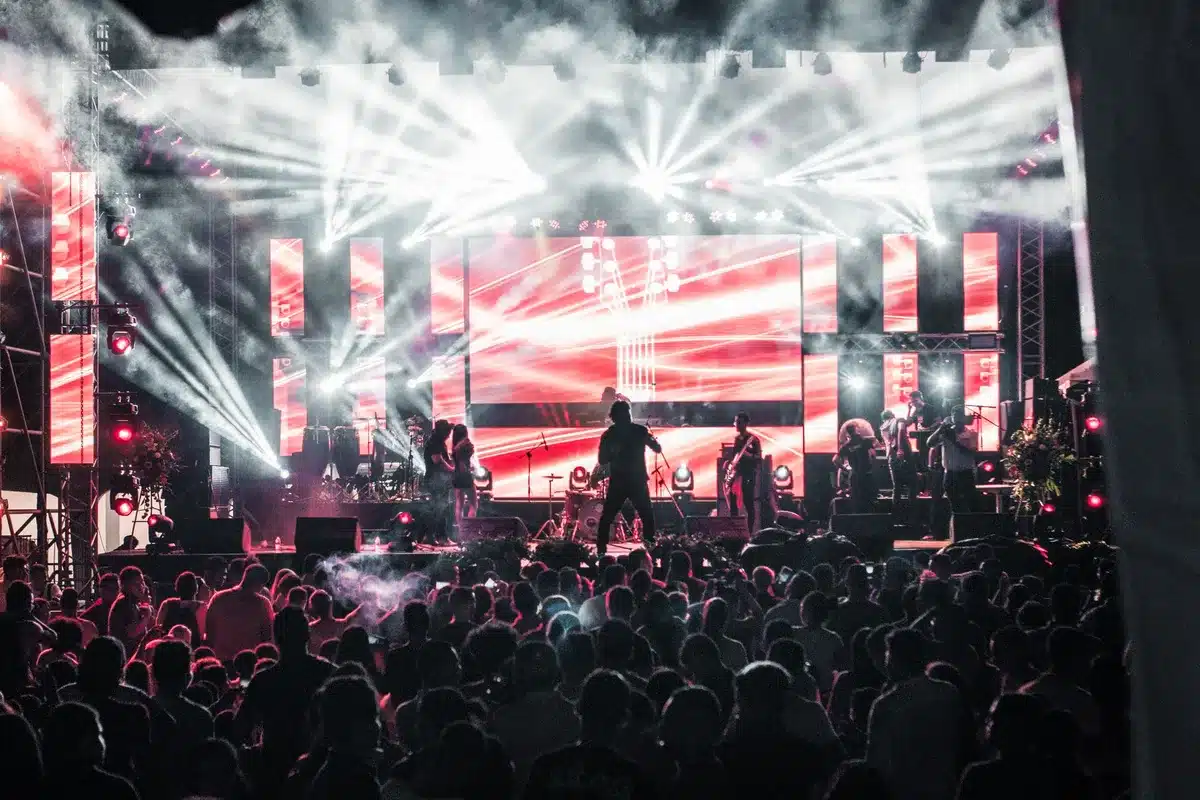 Concert stage with lighting and crowd in distance