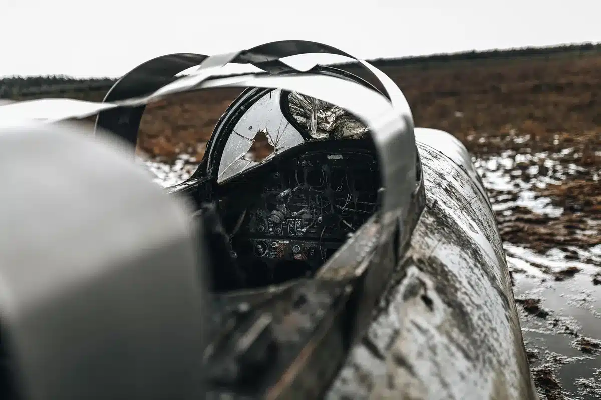 Investigative scene depicting aircraft accident site with safety markers and documentation