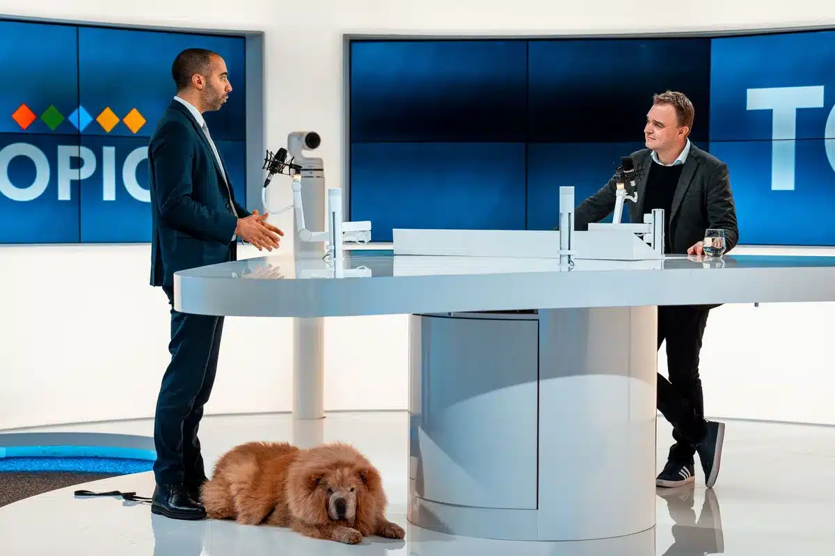 Two people engaged in an intense debate discussion on a television studio set