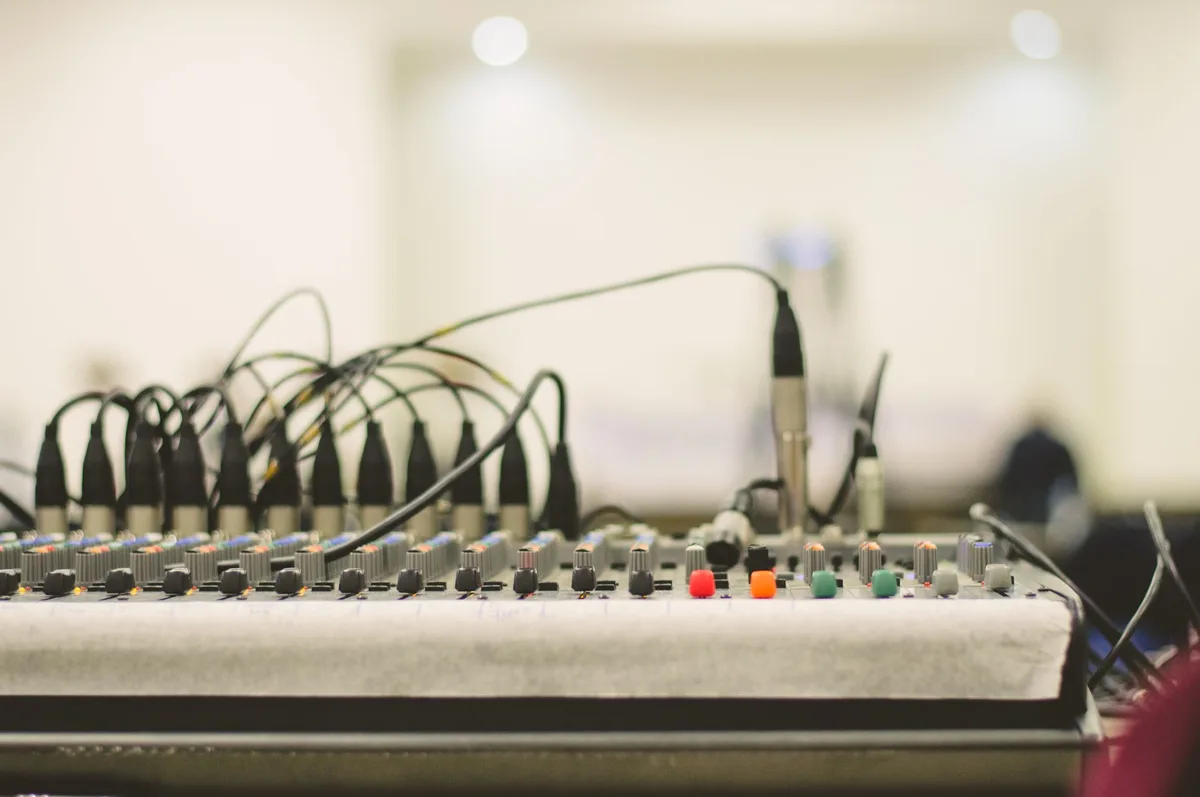 Close-up of stage equipment including microphone stands and cables that can pose hazards during performances