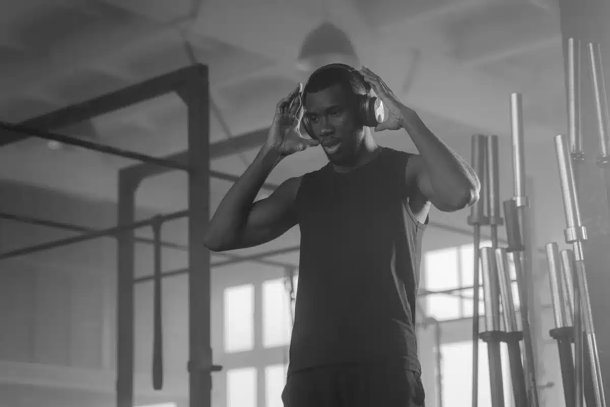 Person wearing headphones during an intense gym workout session