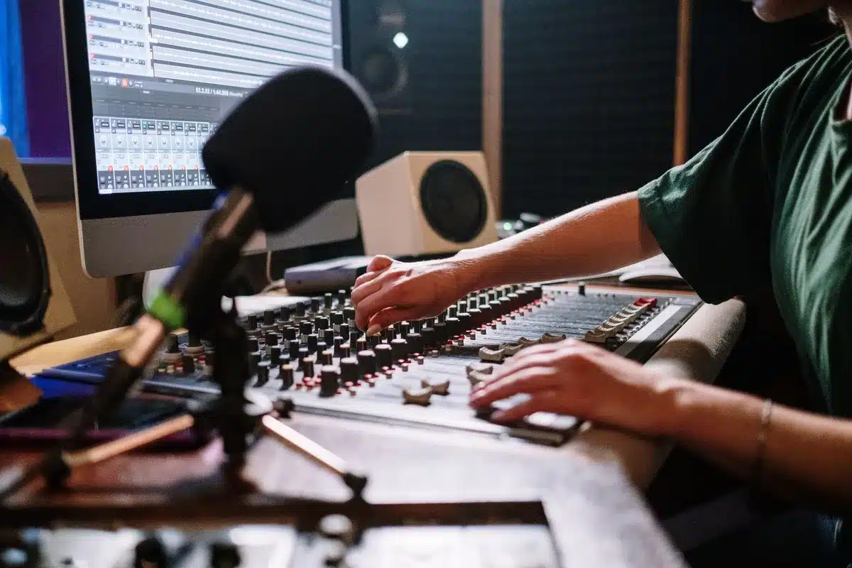 Older person speaking into a microphone in a quiet home recording space