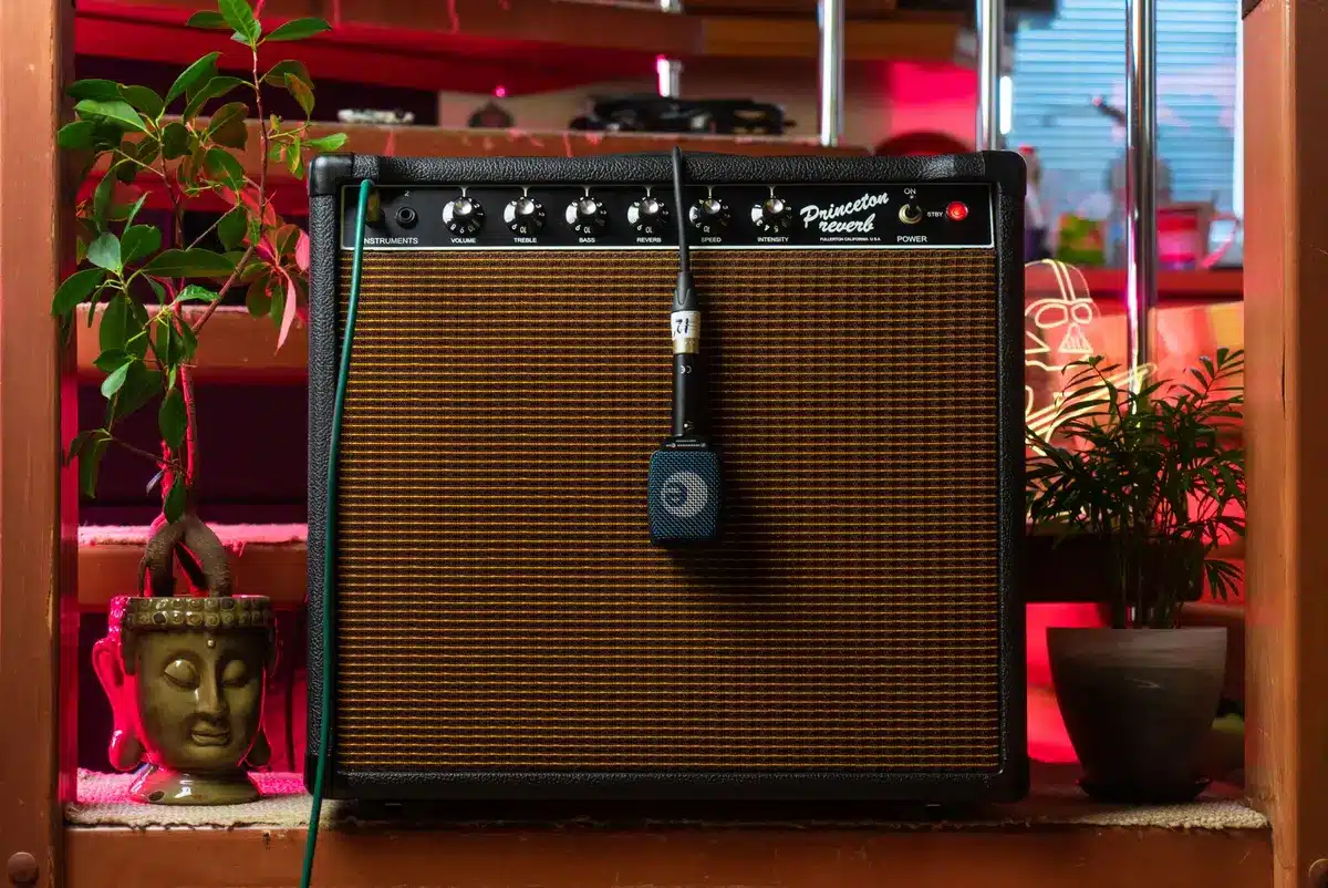 Vintage recording studio with layered amplifiers, reverb pedals, and vinyl records on mixing console
