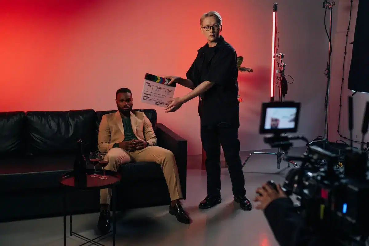 Actor on a film set receiving direction from a filmmaker during a scene