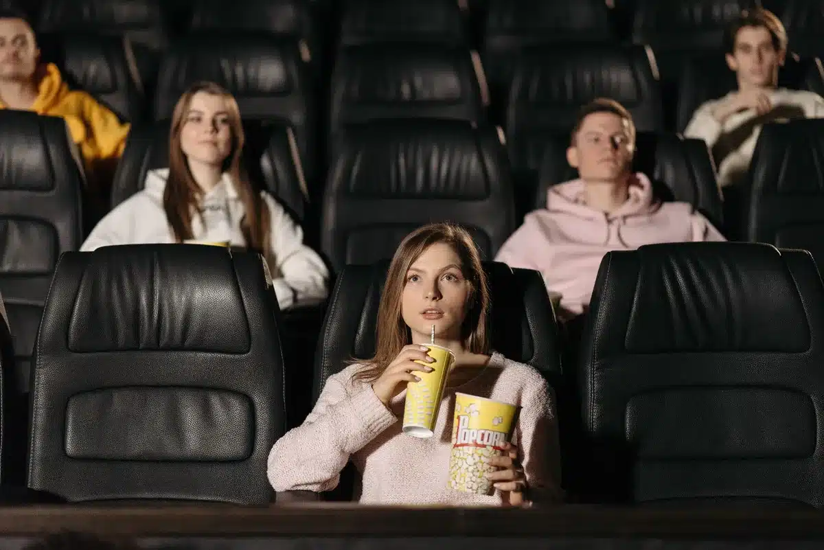 Young moviegoers enjoying snacks and discussing films, representing Gen Z appeal