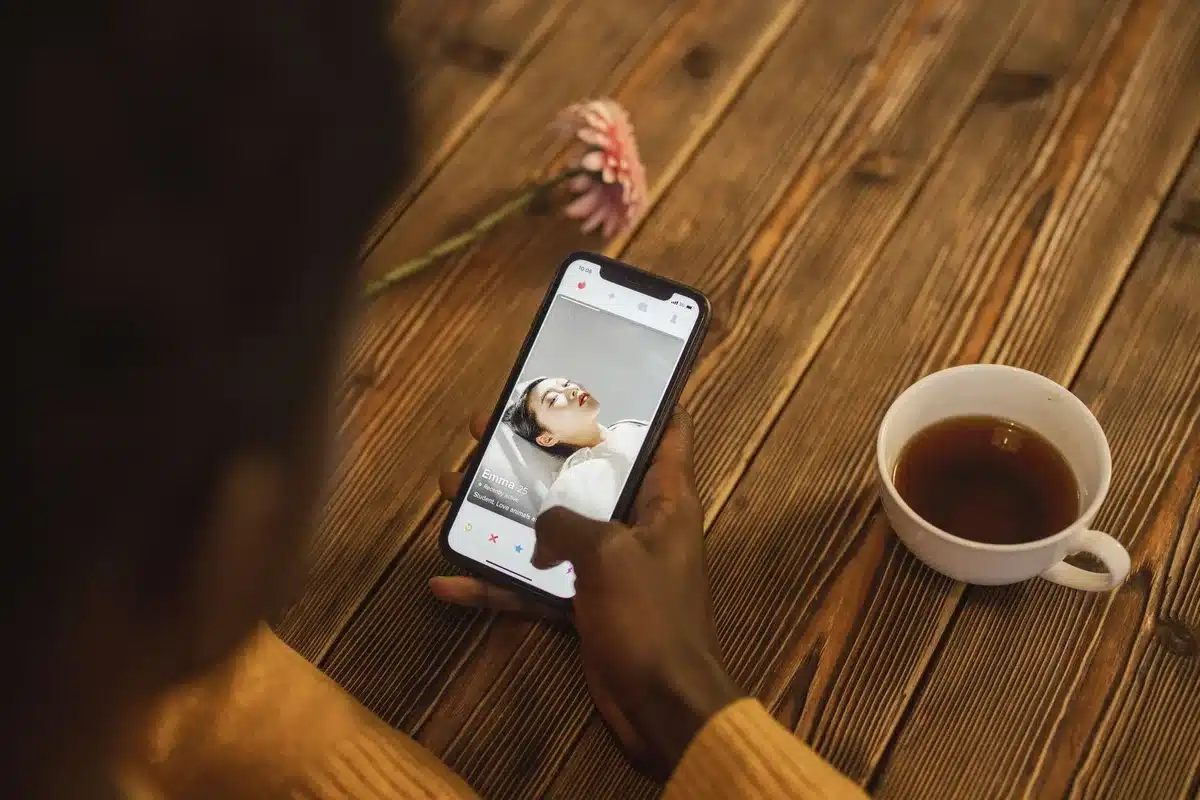 Smartphone screen showing a dating profile with music selection feature