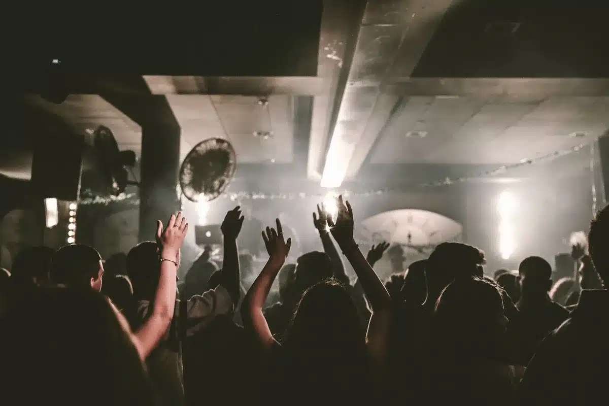 People dancing together in a nightclub with dynamic lighting and energy