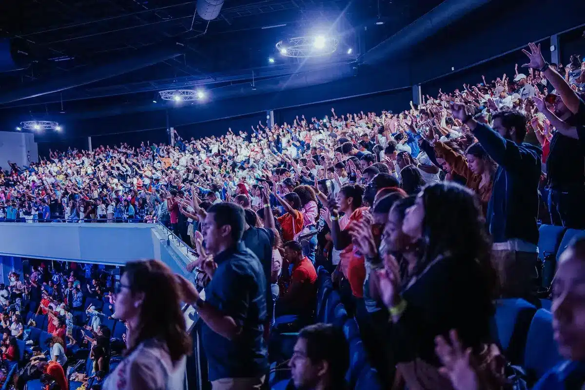 Audience members rising to their feet and applauding in a theater, showing emotional response