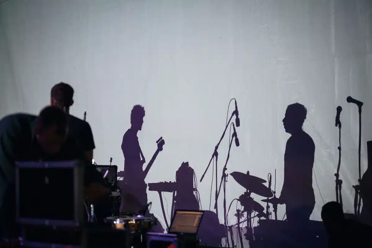 Band performing live on stage during a reunion tour