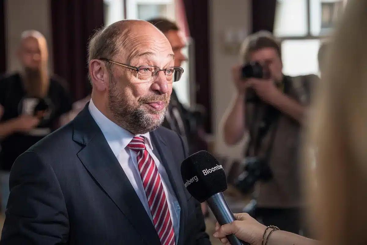 Journalist holding microphone during a political press event